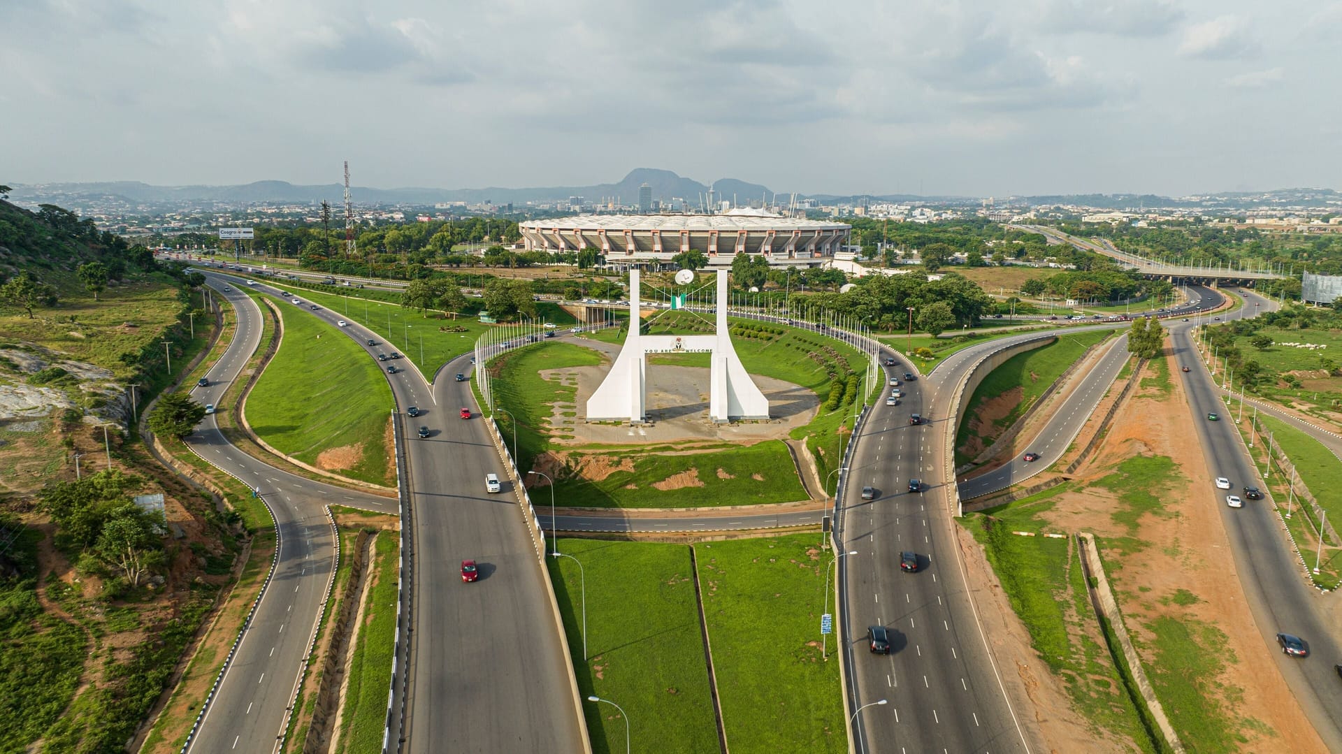 Abuja City Gate, with the National Stadium behind it